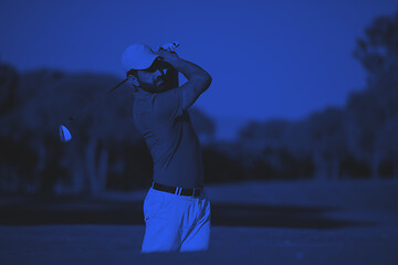 Image showing pro golfer hitting a sand bunker shot