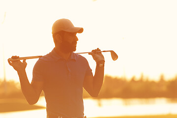 Image showing golfer  portrait at golf course on sunset