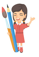 Image showing Smiling girl holding big pencil and paintbrush.