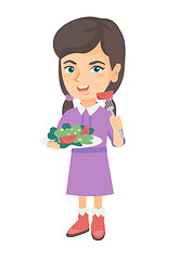 Image showing Little caucasian girl eating vegetable salad.