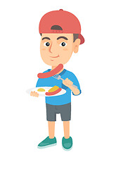 Image showing Boy eating sausage and fried egg for breakfast.