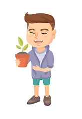 Image showing Caucasian smiling boy holding a potted plant.
