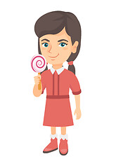 Image showing Little caucasian girl holding a lollipop candy.