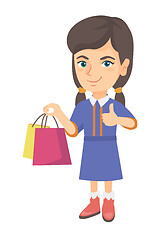 Image showing Happy caucasian girl holding shopping bags.