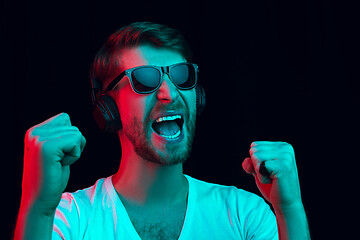 Image showing Enjoying his favorite music.