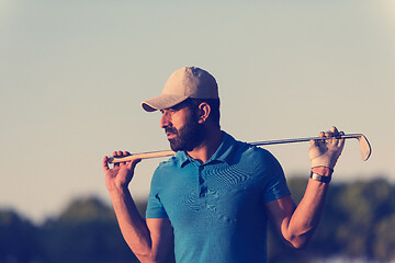 Image showing golfer  portrait at golf course on sunset