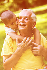 Image showing grandfather and child have fun  in park