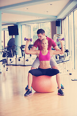 Image showing young sporty woman with trainer exercise weights lifting