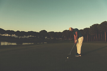 Image showing golfer  hitting shot at golf course