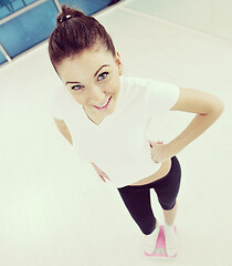 Image showing happy diet concept with young woman on pink scale