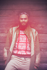 Image showing portrait of young hipster in front of wooden house