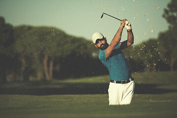 Image showing pro golfer hitting a sand bunker shot