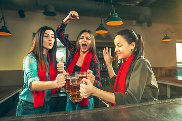 Image showing Sport, people, leisure, friendship and entertainment concept - happy football fans or female friends drinking beer and celebrating victory at bar or pub