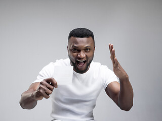 Image showing Young boy with a surprised expression won a bet on blue background