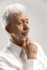 Image showing The serious businessman against gray background.