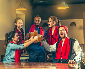 Image showing Sport, people, leisure, friendship and entertainment concept - happy football fans or male friends drinking beer and celebrating victory at bar or pub