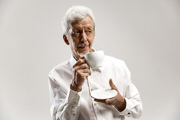 Image showing old age, drink and people concept - happy senior man with cup of tea at home