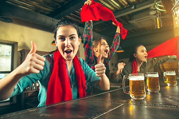 Image showing Sport, people, leisure, friendship and entertainment concept - happy football fans or female friends drinking beer and celebrating victory at bar or pub