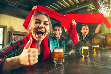 Image showing Sport, people, leisure, friendship and entertainment concept - happy football fans or female friends drinking beer and celebrating victory at bar or pub