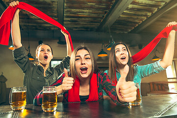 Image showing Sport, people, leisure, friendship and entertainment concept - happy football fans or female friends drinking beer and celebrating victory at bar or pub