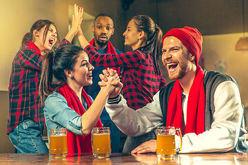 Image showing Sport, people, leisure, friendship and entertainment concept - happy football fans or male friends drinking beer and celebrating victory at bar or pub