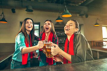 Image showing Sport, people, leisure, friendship and entertainment concept - happy football fans or female friends drinking beer and celebrating victory at bar or pub