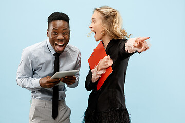 Image showing Concept of partnership in business. Young man and woman standing at studio