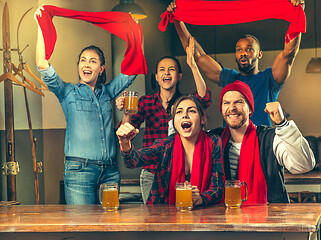 Image showing Sport, people, leisure, friendship and entertainment concept - happy football fans or male friends drinking beer and celebrating victory at bar or pub