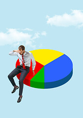 Image showing Businessman sitting on a pie chart