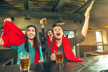 Image showing Sport, people, leisure, friendship and entertainment concept - happy football fans or female friends drinking beer and celebrating victory at bar or pub