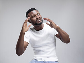 Image showing African american man excited about watching tv.