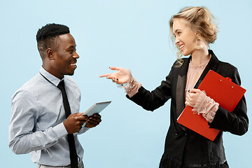 Image showing Concept of partnership in business. Young man and woman standing at studio