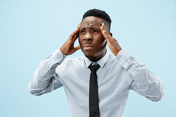 Image showing Man having headache. Isolated over blue background.