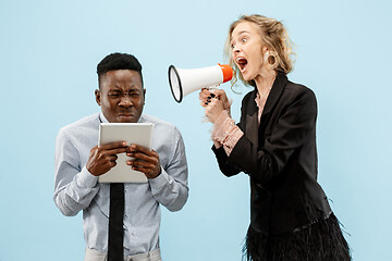 Image showing angry businesswoman and colleague in the office.