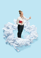 Image showing Concept of a new idea. A woman and crumpled pieces of paper