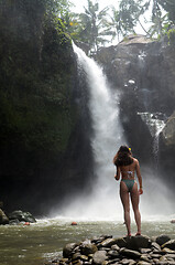 Image showing Young beautiful tourist visiting the Tegenungan waterfall in Bal