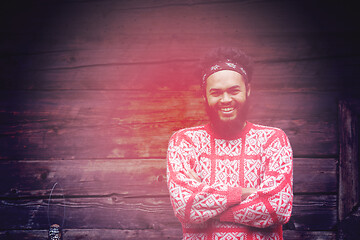 Image showing portrait of young hipster in front of wooden house