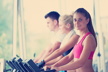 Image showing friends  exercising on a treadmill at the bright modern gym