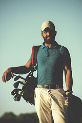 Image showing golfer  portrait at golf course on sunset