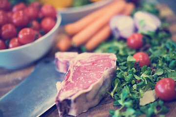 Image showing Juicy slice of raw steak on wooden table