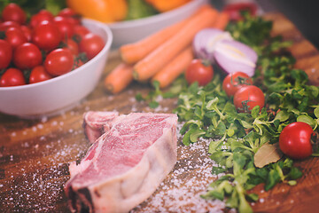 Image showing Juicy slice of raw steak on wooden table