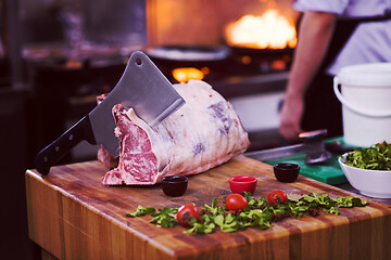 Image showing chef cutting big piece of beef