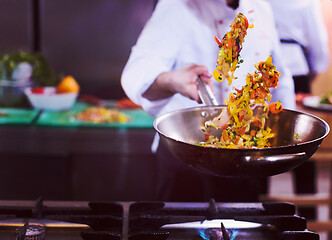 Image showing chef flipping vegetables in wok