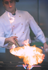 Image showing Chef doing flambe on food