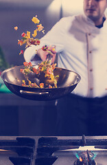 Image showing chef flipping vegetables in wok