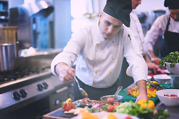 Image showing Chef finishing steak meat plate