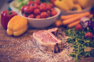 Image showing Juicy slice of raw steak on wooden table
