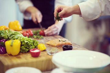 Image showing Chef hands preparing marinated Salmon fish