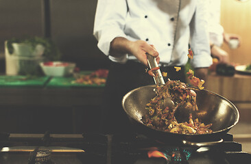 Image showing chef flipping vegetables in wok