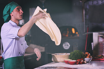 Image showing chef throwing up pizza dough